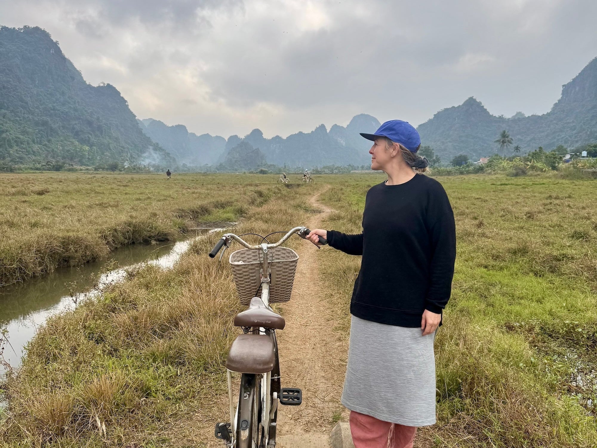 Shannon in Vietnam with Bike in Fields